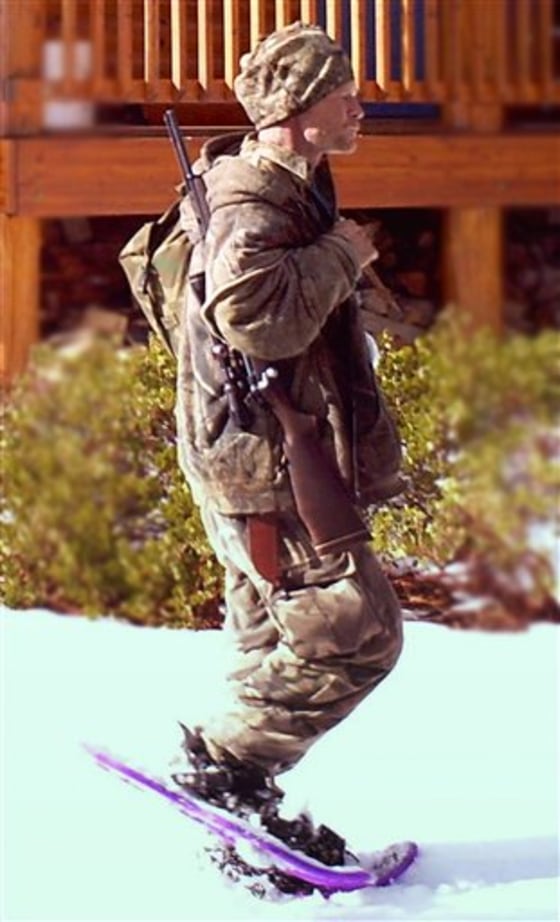 In this undated photo provided by the Iron County Sheriff's Office in January, a man is seen walking past a cabin in the remote southern Utah wilderness near Zion National Park. Authorities believe the man in the photo, captured by a motion-triggered surveillance camera sometime in December, is a suspect responsible for more than two dozen cabin burglaries over the past five years.